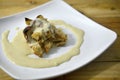 Close up bread butter pudding in white plate on wooden table background Royalty Free Stock Photo