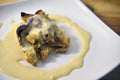 Close up bread butter pudding in white plate on wooden table background