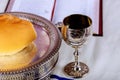 Close up of bread and a cup of red wine on wooden table for communion, Christian concept for reminder of Jesus Royalty Free Stock Photo