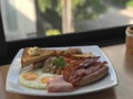 close up breakfast plate include fried eggs, ham, sausages, potatoes, tomatoes, mushrooms, beans Royalty Free Stock Photo