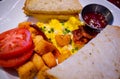 Close up of Breakfast with Toasted Bread, Scrambled eggs, and Tomato. Royalty Free Stock Photo