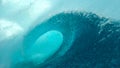 CLOSE UP: Breathtaking barrel wave crashes and splashes glassy ocean water. Royalty Free Stock Photo