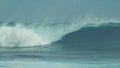 CLOSE UP: Breathtaking blue barrel wave crashing towards the tropical shore. Royalty Free Stock Photo