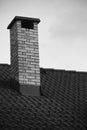Close up on brick chimney on rooftop isolated in black and white