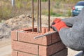 Close up on brick laying blocks correctly on fence brick column. Whether you are laying brick to build a mailbox enclosure