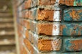 Close-up of a brick wall with remnants of color drawings