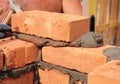 Close up on bricklayer hands laying bricks.