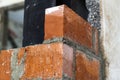 Close up of bricklaying industrial installing bricks on construction site wall Royalty Free Stock Photo