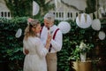 Close-up of bride and groom dancing at their outdoor wedding party. Royalty Free Stock Photo