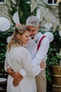 Close-up of bride and groom dancing at their outdoor wedding party. Royalty Free Stock Photo