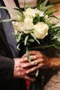 Close-up of bride and groom holding bridal bouquet. Royalty Free Stock Photo