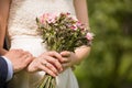 Close-up of bride and groom holding hands. Wedding outdoors. Newly married couple - wedding details. Just married Royalty Free Stock Photo