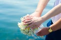 Close-up Bride and groom`s hands with wedding rings and bouquet. Love and marriage. Wedding accessories and decor on the backgrou Royalty Free Stock Photo