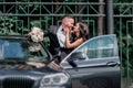 Close up. bride and groom standing near the car Royalty Free Stock Photo