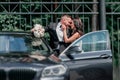 Close up. bride and groom standing near the car Royalty Free Stock Photo