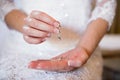 Bride holding her silver earrings Royalty Free Stock Photo