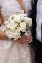 Close-up of bride hold wedding bouquet in hands. Beautiful white flowers Royalty Free Stock Photo