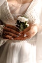 Close up bride holding buttonhole in hands close up Royalty Free Stock Photo