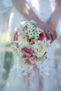 Close up of the bride`s hands holding a bouquet of flowers. Bridal bouquet, hold the wedding bouquet Royalty Free Stock Photo