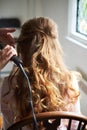 Close up on bride wedding hairdo with electric hair curler Royalty Free Stock Photo