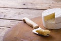 Close-up of brie cheese and knife on board at table, copy space Royalty Free Stock Photo