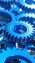 Close-up of bright blue gears meshing together industrial design engineering concept Royalty Free Stock Photo