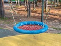 Close-up of a bright blue nest swing in a children`s park