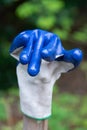 Funny waving garden glove close up bright blue