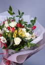 Close up of a bright bouquet of white roses, colored irises and red tulips. Royalty Free Stock Photo