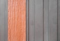 Bright brown plank wood wall texture in vertical patterns on dark grey background Royalty Free Stock Photo