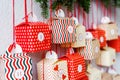 Close up of bright handmade advent calendar red gift boxes hanging on the wall.