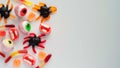 Close-up bright jelly candies,spiders,eyes,jaws,worms and bats,on white background,top view,flat lay,copy space.Decor concept for