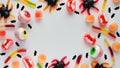 Close-up bright jelly candies,spiders,eyes,jaws,worms and bats,on white background,top view,flat lay,copy space.Decor concept for