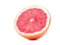 A slice of ripe grapefruit, isolated on a white background. Fresh, juicy, organic and cut in a half grapefruit full of vitamins. Royalty Free Stock Photo