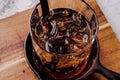 Close up, brown alcoholic cocktail with whiskey, ice cubes decorations on a wooden board, gray background. Bar alcohol Royalty Free Stock Photo