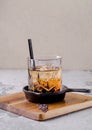 Close up, brown alcoholic cocktail with whiskey, ice cubes decorations on a wooden board, gray background. Bar alcohol Royalty Free Stock Photo