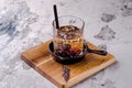 Close up, brown alcoholic cocktail with whiskey, ice cubes decorations on a wooden board, gray background. Bar alcohol Royalty Free Stock Photo