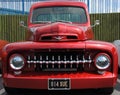 Close up of a bright red 1960s American pick up truck