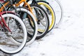 Close-up on the bright wheels of bicycles that stand on the snow Royalty Free Stock Photo