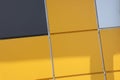 Close up of bright yellow wall with gray panels. Geometric background Royalty Free Stock Photo