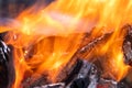 Close up of brightly burning wooden logs with yellow hot flames of fire at night Royalty Free Stock Photo