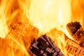 Close up of brightly burning wooden logs with yellow hot flames of fire at night Royalty Free Stock Photo