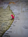 Close up of Brisbane pin pointed on the world map with a pink pushpin Royalty Free Stock Photo