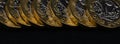 Close up of British pound coins in a row on black background, web banner Royalty Free Stock Photo