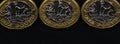 Close up of British pound coins in a row on black background, web banner Royalty Free Stock Photo