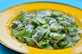 Close-up of broad bean salad with hard cheese.