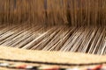 Close up of brocade fabric weaving on loom, cotton on the manual wood loom in Ouarzazate, Morocco