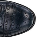 Close-Up of Brogue Detail on Navy Blue Leather Oxford Shoe