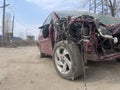 Close up of broken and abandoned car. Smashed car to pieces after accident on street. Concept of careless driving.