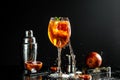 Close up of broken Aperol spritz cocktail in big wine glass on black background for food and drink design with water Splash, The Royalty Free Stock Photo